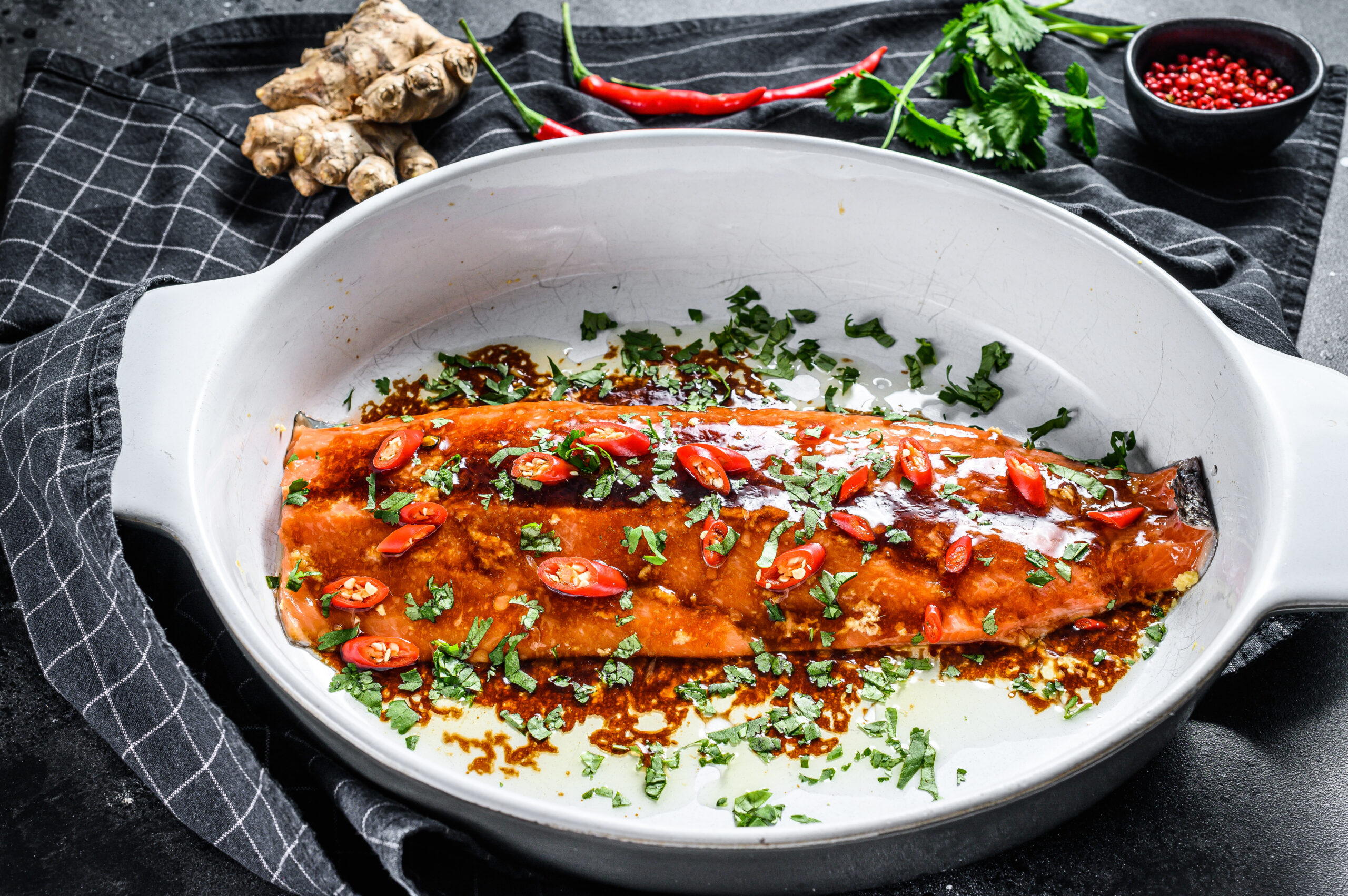 Cooking of salmon fillet teriyaki. Black background. Top view.